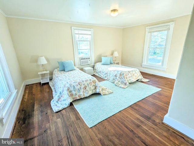 bedroom featuring ornamental molding, dark wood-type flooring, cooling unit, and multiple windows