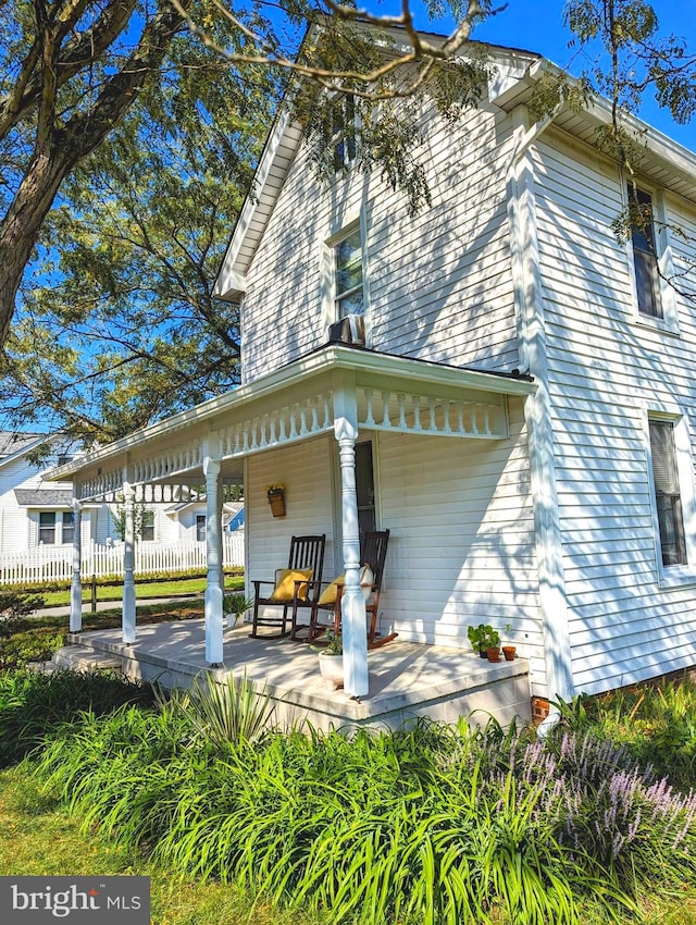 rear view of house with covered porch