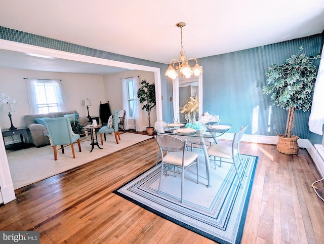 dining area with a notable chandelier and wood-type flooring