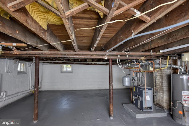 below grade area featuring water heater and a heating unit