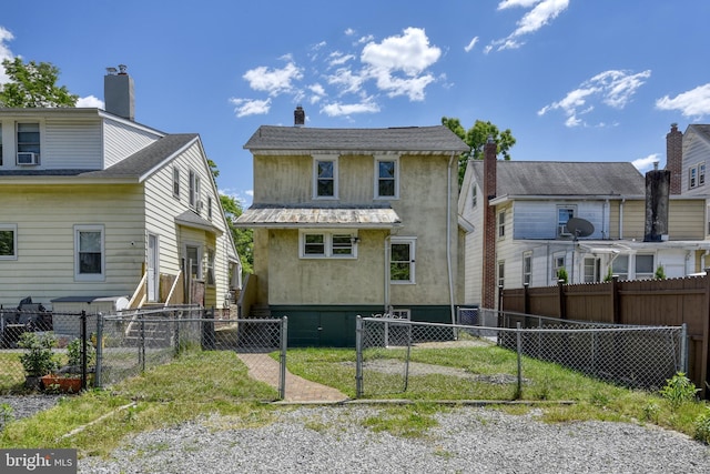 back of property featuring metal roof, cooling unit, a fenced backyard, and stucco siding