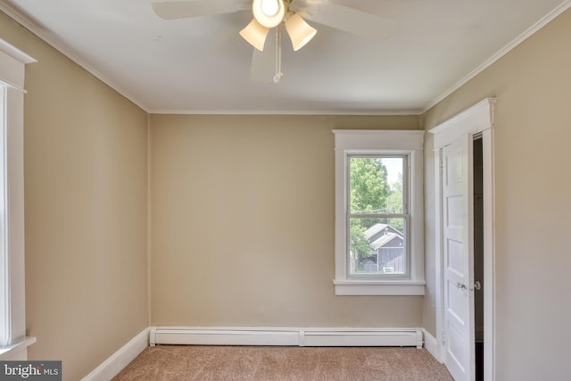 spare room with a baseboard heating unit, ceiling fan, carpet flooring, and baseboards