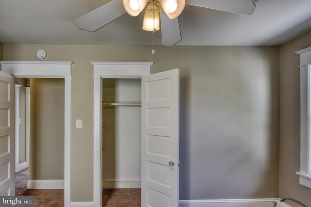 unfurnished bedroom featuring carpet, a closet, and baseboards