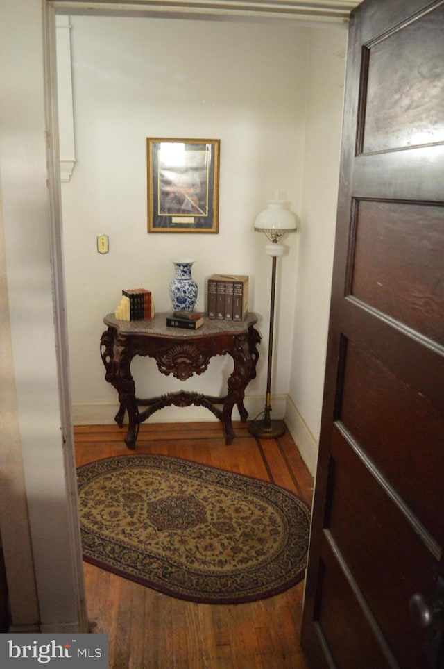 entryway with wood finished floors and baseboards