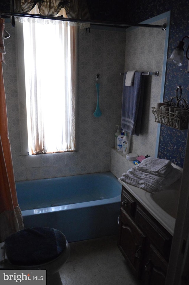 full bathroom with a washtub, toilet, vanity, walk in shower, and wallpapered walls