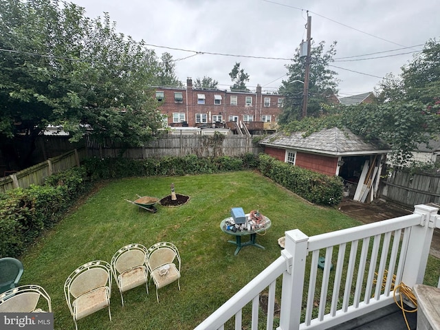 view of yard featuring a fenced backyard and an outbuilding