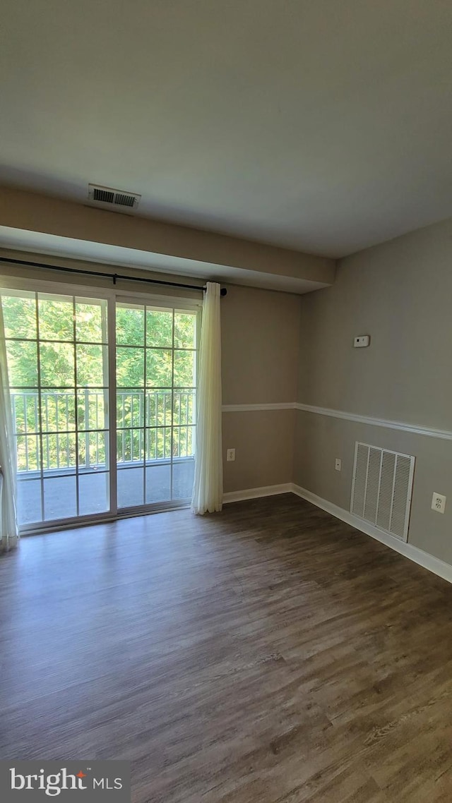 spare room featuring dark wood-type flooring