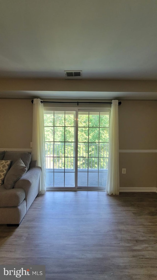 unfurnished living room featuring wood-type flooring