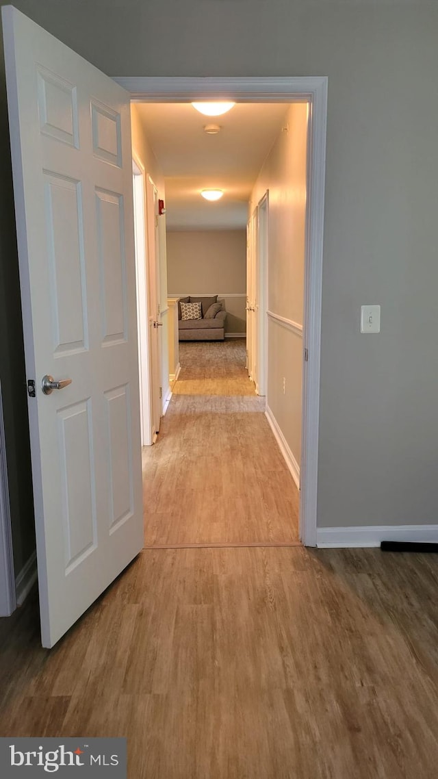 hallway with wood-type flooring