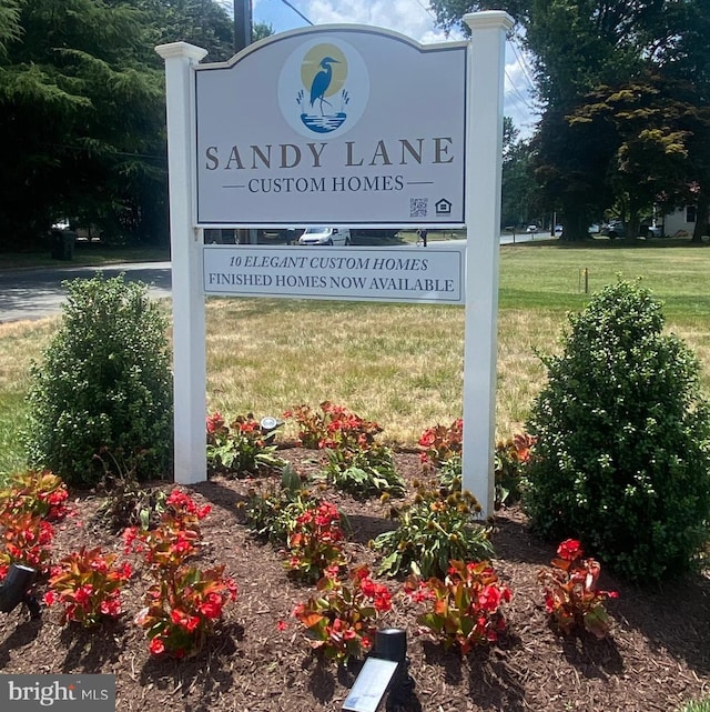 community / neighborhood sign with a lawn