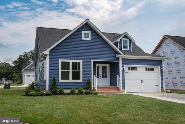 view of front of house featuring a garage and a front yard