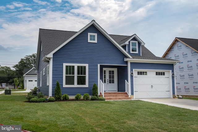 view of front of house with an attached garage, a front lawn, concrete driveway, and roof with shingles