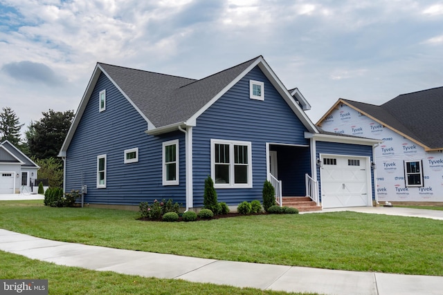 view of front of property featuring a garage and a front yard