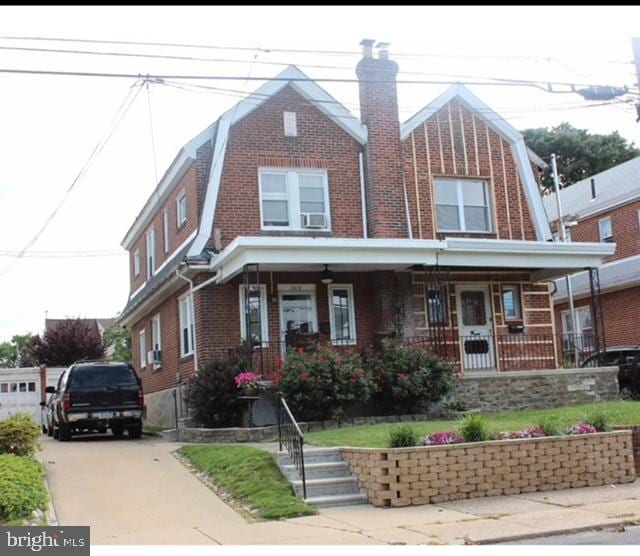 view of front facade featuring cooling unit and a porch