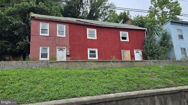 view of front of property with a front lawn and a chimney