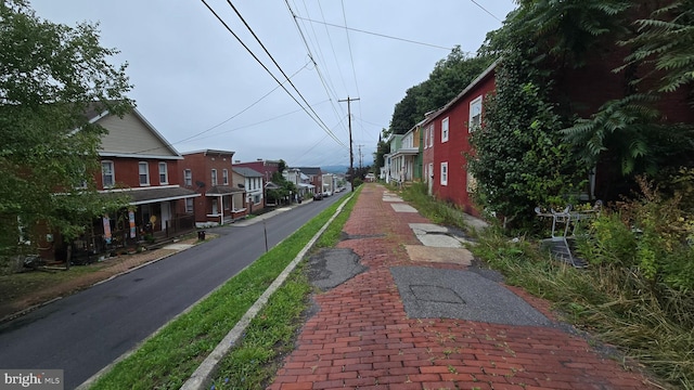 view of street with sidewalks and a residential view