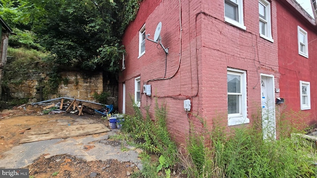 view of side of home featuring brick siding