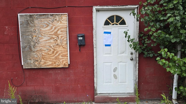 property entrance featuring concrete block siding