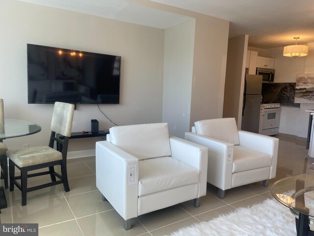 tiled living room with an inviting chandelier