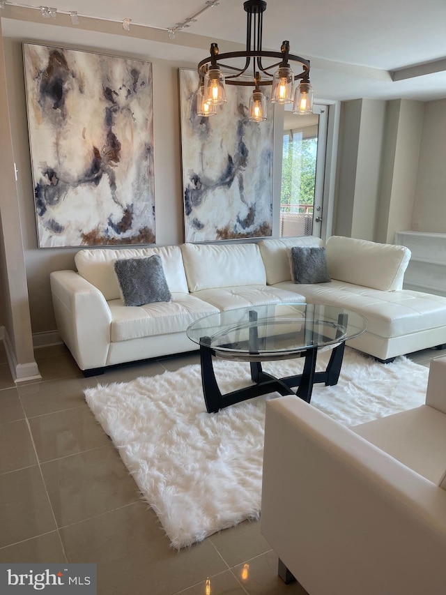 living room featuring tile patterned floors and an inviting chandelier