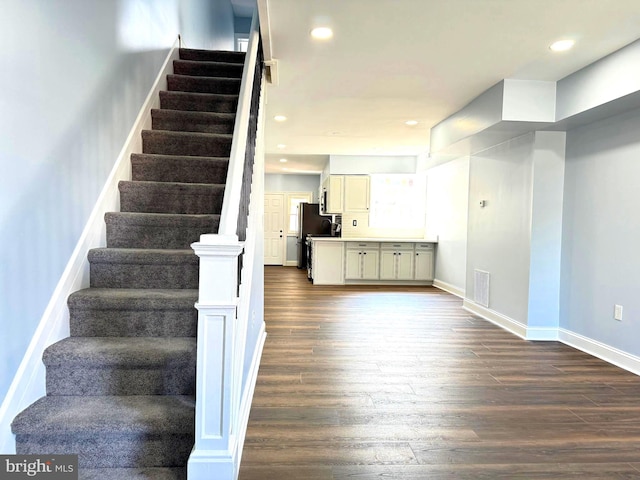 staircase with hardwood / wood-style flooring