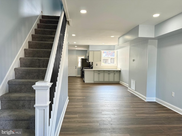 stairs with hardwood / wood-style floors