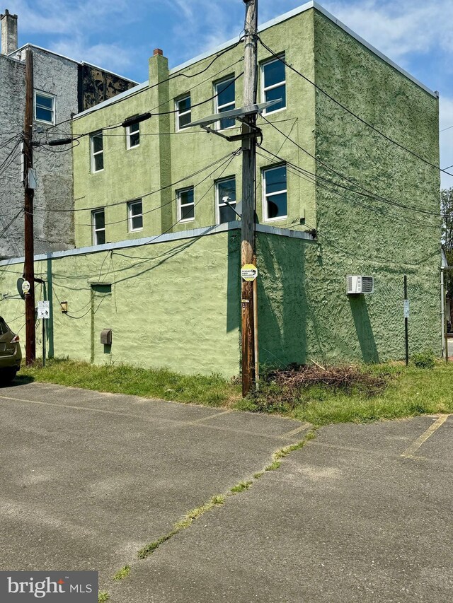 view of building exterior featuring an AC wall unit