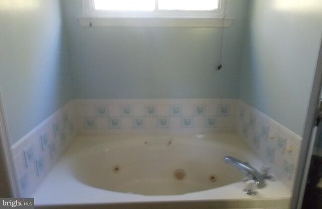 bathroom featuring a tub to relax in