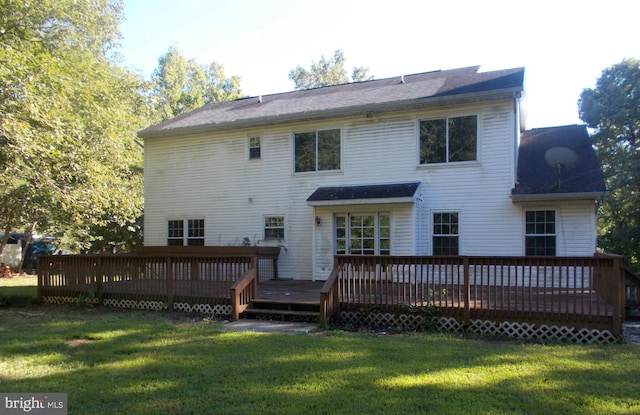 back of house with a wooden deck and a yard