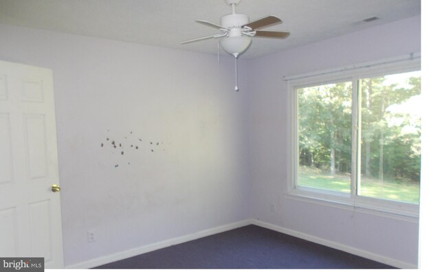 empty room featuring ceiling fan and a healthy amount of sunlight