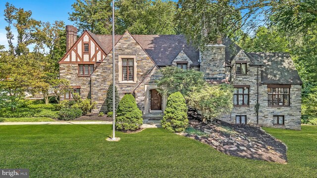 tudor house featuring a front lawn