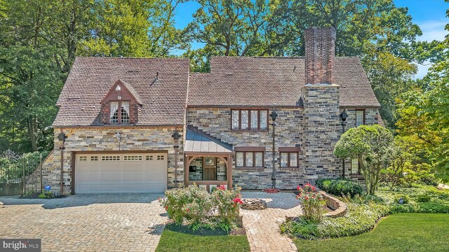 english style home with a garage