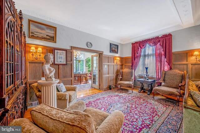 living area featuring ornamental molding, a wealth of natural light, and wood finished floors