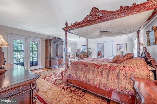 bedroom featuring access to outside, french doors, and light wood-style flooring