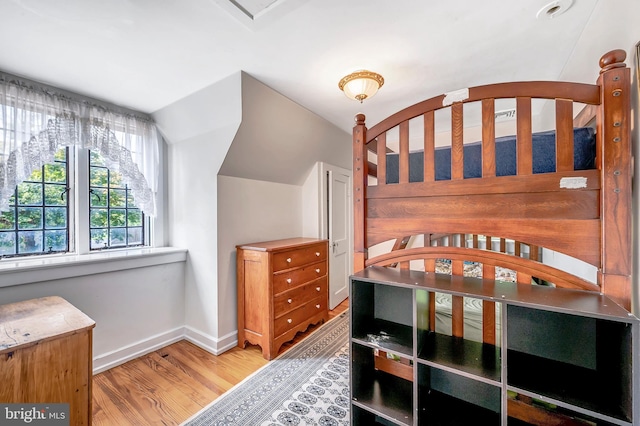 bedroom featuring baseboards and wood finished floors