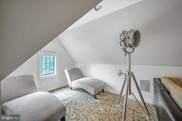 sitting room with lofted ceiling and baseboards