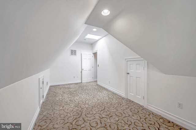 bonus room with lofted ceiling with skylight, baseboards, visible vents, and carpet flooring