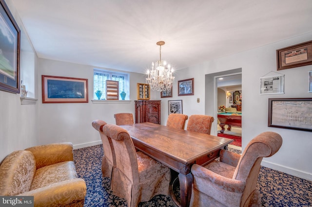 dining room featuring an inviting chandelier, carpet flooring, and baseboards