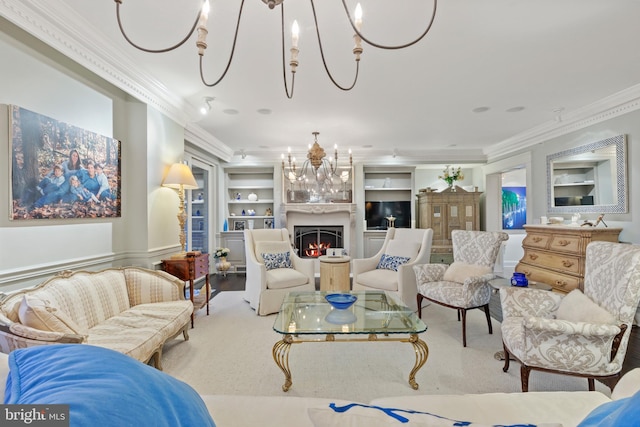 living room featuring crown molding, built in shelves, and an inviting chandelier