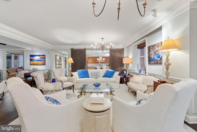 living room with ornamental molding, hardwood / wood-style floors, and an inviting chandelier