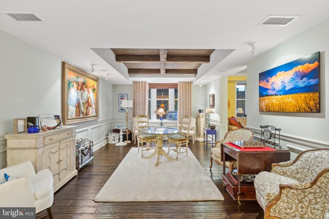 dining area featuring dark wood-type flooring, coffered ceiling, and beam ceiling