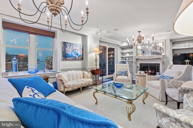 living room with built in features, a fireplace, a chandelier, and crown molding