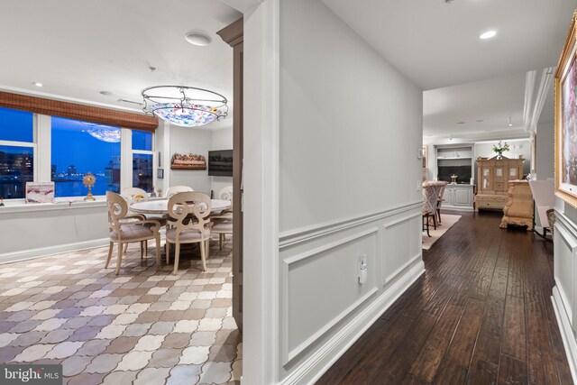 corridor featuring hardwood / wood-style floors and an inviting chandelier