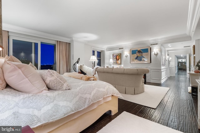 bedroom with crown molding, dark hardwood / wood-style flooring, and access to outside