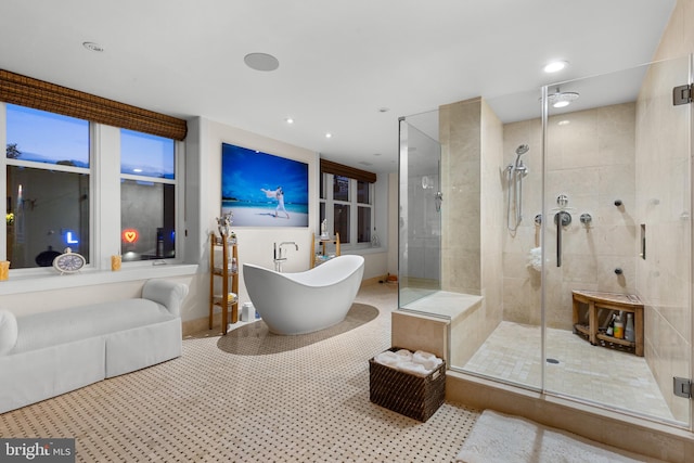 bathroom featuring tile patterned flooring and shower with separate bathtub