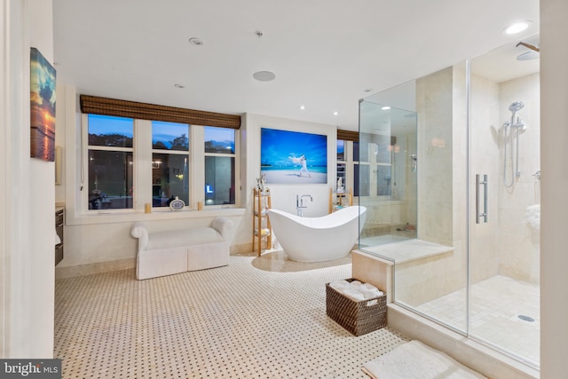 bathroom featuring separate shower and tub