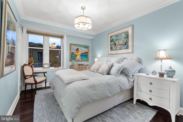 bedroom featuring ornamental molding, dark hardwood / wood-style floors, and a chandelier