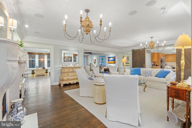 living room featuring ornamental molding, dark wood-type flooring, and a notable chandelier