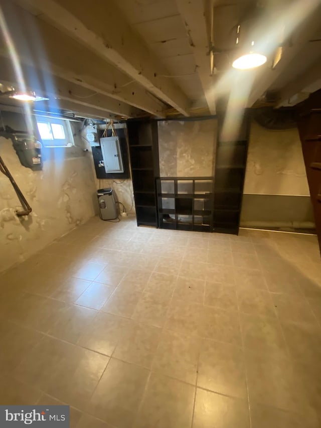 basement with electric panel and tile patterned floors