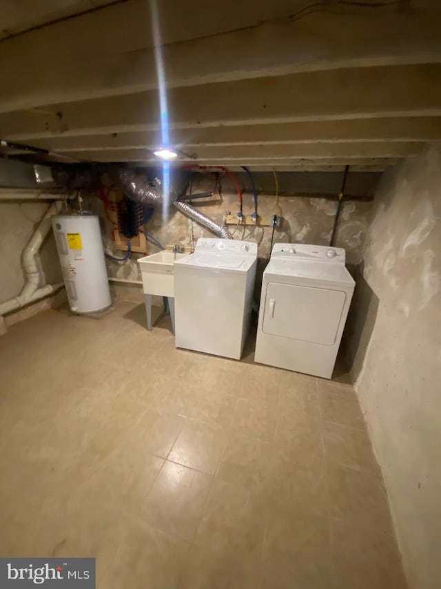 basement with washer and dryer, sink, and water heater